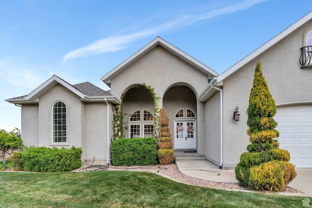 2382 S Spanish Oaks Dr, Spanish Fork, UT 84660 - view of front of property with an attached garage, a front lawn, stucco siding, and french doors