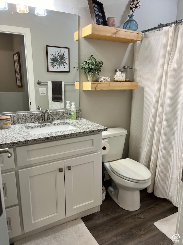 1036 S Fir St, Cedar City, UT 84720 - full bath with vanity, a shower with shower curtain, toilet, and wood finished floors