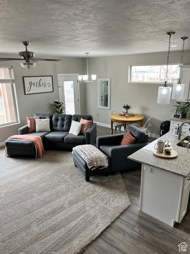 1036 S Fir St, Cedar City, UT 84720 - living room with a ceiling fan, baseboards, a textured ceiling, and dark wood-style flooring