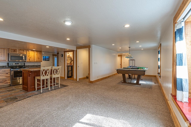 717 E Park Dr N, Hyrum, UT 84319 - rec room featuring recessed lighting, a textured ceiling, baseboards, and dark colored carpet