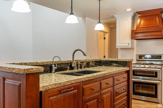 717 E Park Dr N, Hyrum, UT 84319 - kitchen featuring pendant lighting, custom range hood, a sink, double oven range, and white cabinetry