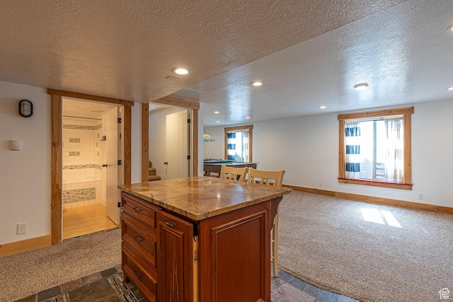 717 E Park Dr N, Hyrum, UT 84319 - kitchen featuring baseboards, brown cabinets, and dark carpet