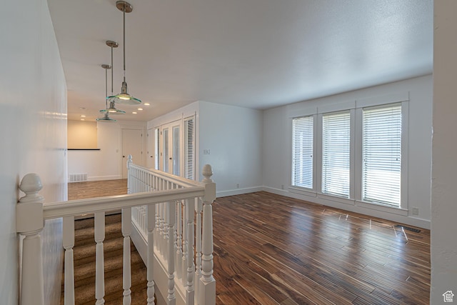 717 E Park Dr N, Hyrum, UT 84319 - hall featuring wood finished floors, baseboards, visible vents, recessed lighting, and an upstairs landing