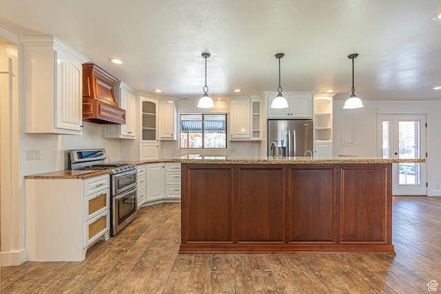 717 E Park Dr N, Hyrum, UT 84319 - kitchen with plenty of natural light, stainless steel appliances, and glass insert cabinets