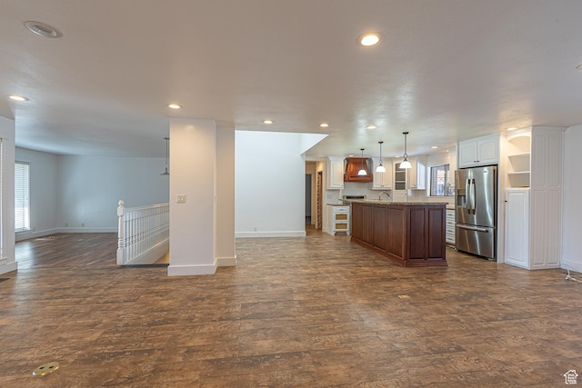 717 E Park Dr N, Hyrum, UT 84319 - kitchen with dark wood-type flooring, open floor plan, stainless steel fridge, and a wealth of natural light