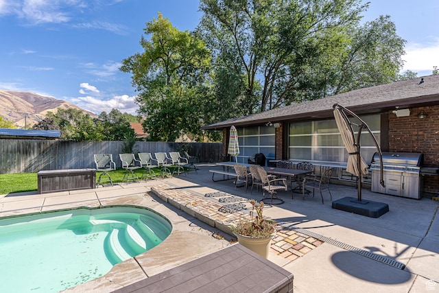 717 E Park Dr N, Hyrum, UT 84319 - view of pool with a patio area, fence, a mountain view, and a grill