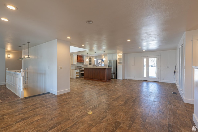 717 E Park Dr N, Hyrum, UT 84319 - unfurnished living room featuring dark wood-type flooring, recessed lighting, and visible vents