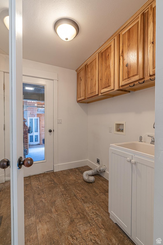 717 E Park Dr N, Hyrum, UT 84319 - laundry room with baseboards, dark wood-style flooring, hookup for a washing machine, cabinet space, and a sink
