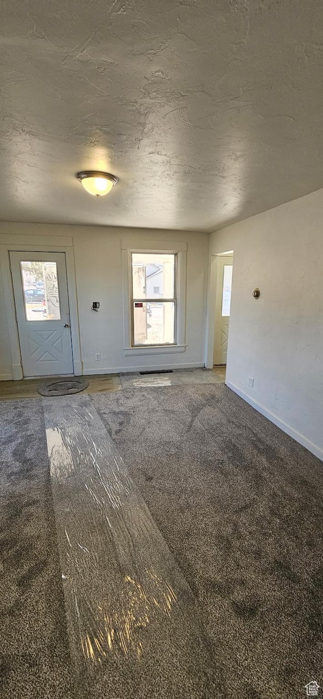 279 E 2nd St N, Downey, ID 83234 - interior space with baseboards, carpet floors, and a textured ceiling