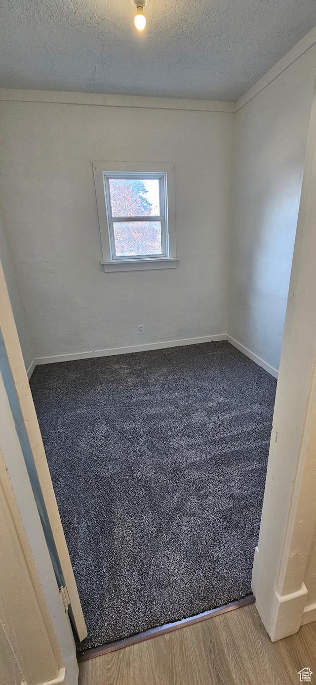 279 E 2nd St N, Downey, ID 83234 - empty room with a textured ceiling, baseboards, and wood finished floors