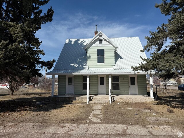 279 E 2nd St N, Downey, ID 83234 - view of front of house featuring a porch, metal roof, and a chimney