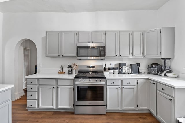 739 24th St, Ogden, UT 84401 - kitchen featuring light countertops, dark wood-style floors, gray cabinets, and appliances with stainless steel finishes