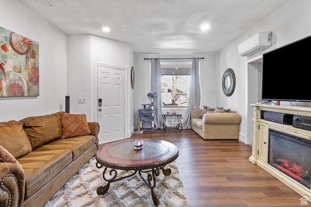 739 24th St, Ogden, UT 84401 - living area featuring a glass covered fireplace, wood finished floors, recessed lighting, and a wall unit AC