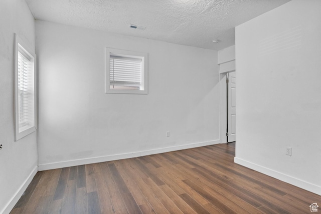739 24th St, Ogden, UT 84401 - spare room with a textured ceiling, dark wood-style floors, visible vents, and baseboards