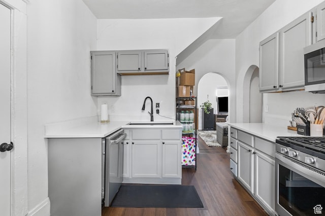 739 24th St, Ogden, UT 84401 - kitchen with gray cabinetry, a sink, appliances with stainless steel finishes, light countertops, and dark wood-style flooring