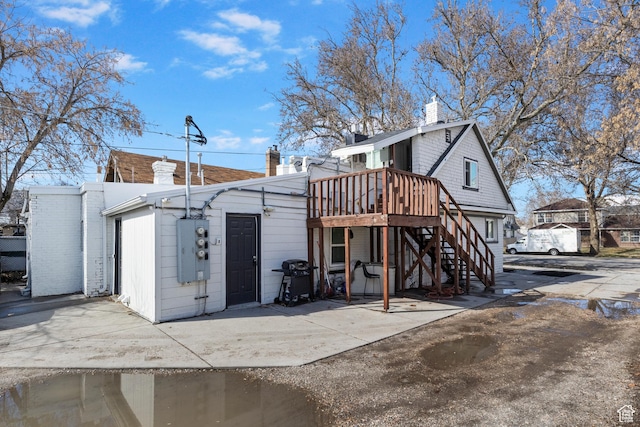 739 24th St, Ogden, UT 84401 - back of property featuring a wooden deck, a chimney, and stairs