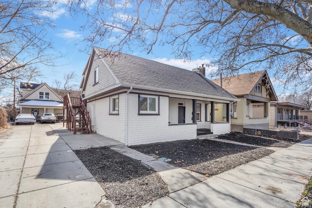 739 24th St, Ogden, UT 84401 - view of side of home with brick siding, a chimney, and roof with shingles