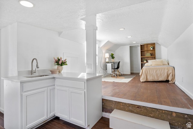 739 24th St, Ogden, UT 84401 - bedroom with dark wood-type flooring, a sink, a textured ceiling, lofted ceiling, and ornate columns