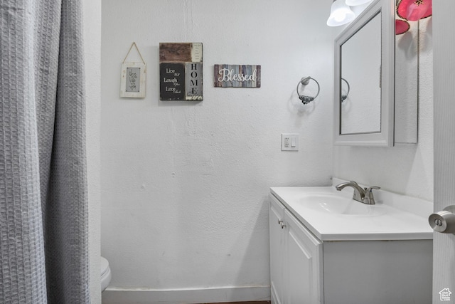 739 24th St, Ogden, UT 84401 - bathroom featuring toilet, vanity, and a textured wall