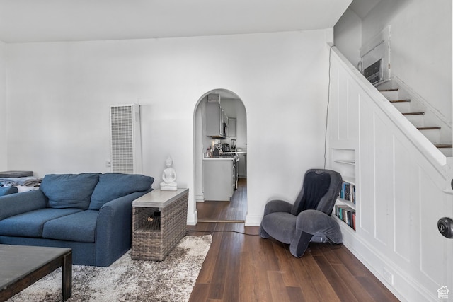 739 24th St, Ogden, UT 84401 - living room featuring visible vents, arched walkways, dark wood-style floors, and stairs