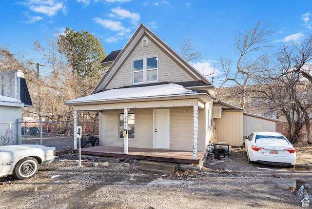 739 24th St, Ogden, UT 84401 - view of front of property with brick siding, covered porch, and fence
