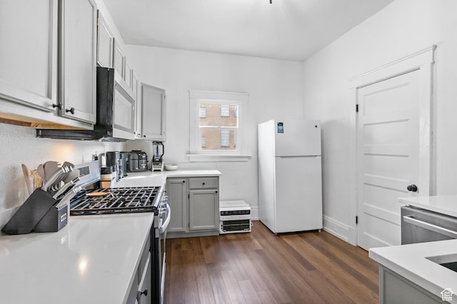 739 24th St, Ogden, UT 84401 - kitchen with light countertops, dark wood-style floors, gray cabinets, and stainless steel appliances