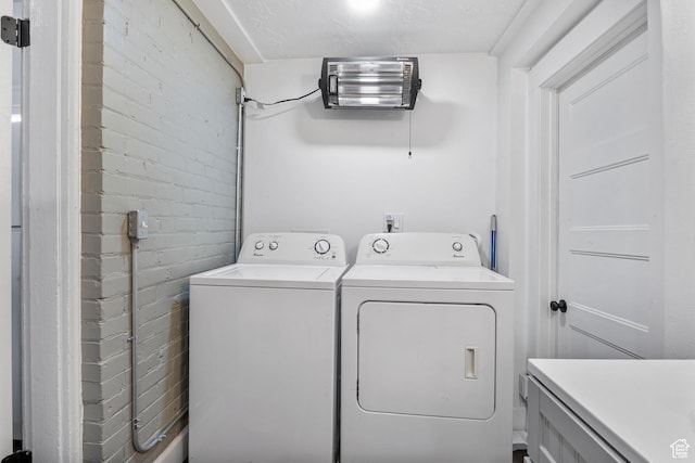 739 24th St, Ogden, UT 84401 - laundry room with washer and dryer, laundry area, and brick wall