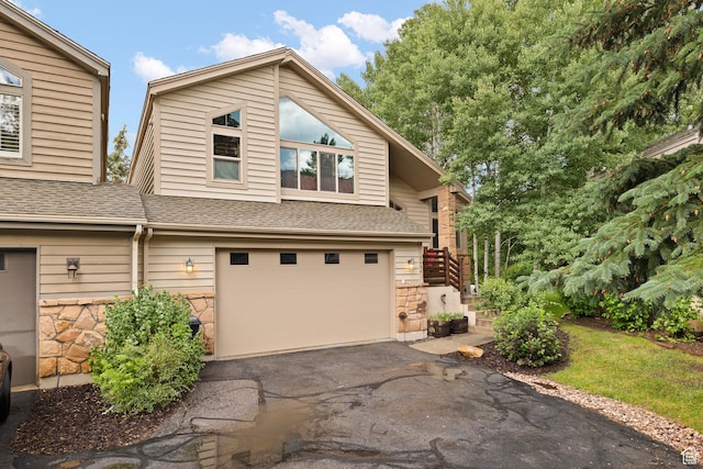 7494 Brook Hollow Loop Rd, Park City, UT 84098 - view of front facade featuring an attached garage, driveway, stone siding, and roof with shingles