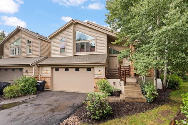 7494 Brook Hollow Loop Rd, Park City, UT 84098 - view of front of house featuring an attached garage, asphalt driveway, stone siding, and roof with shingles