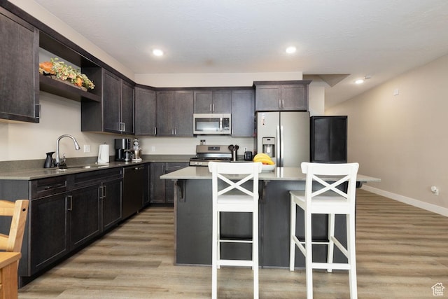 3180 W 1650 N Unit B, Cedar City, UT 84721 - kitchen with a kitchen bar, light wood finished floors, appliances with stainless steel finishes, and a sink