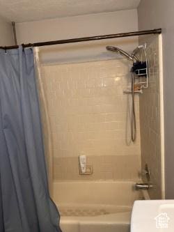 full bathroom with shower / tub combo with curtain