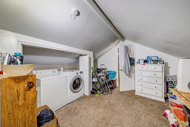 laundry area with a textured ceiling, washing machine and dryer, carpet flooring, and laundry area