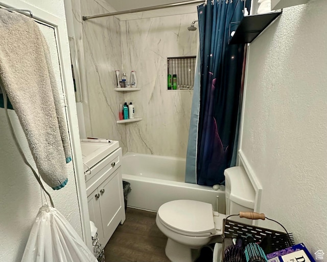 bathroom featuring wood finished floors, a textured wall, and shower / bathtub combination with curtain