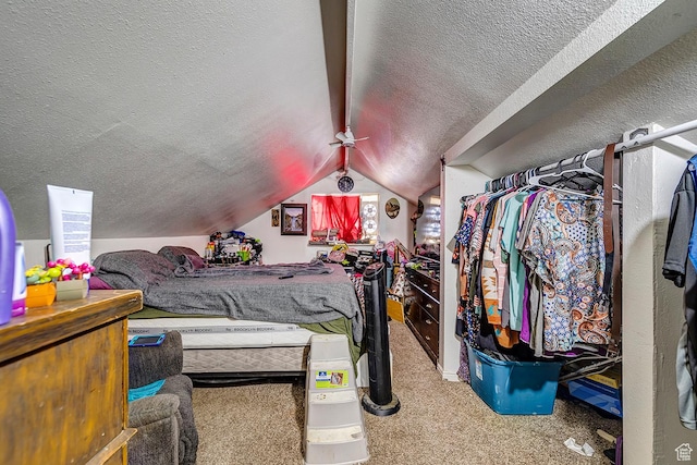 carpeted bedroom with vaulted ceiling with beams and a textured ceiling