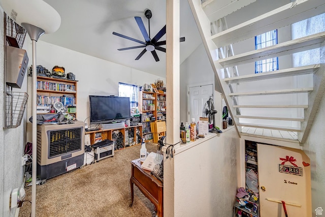 carpeted living room featuring lofted ceiling and ceiling fan