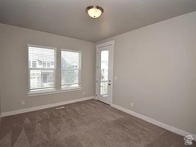 4929 W Red Ruby Ln, Herriman, UT 84096 - spare room with baseboards and dark carpet