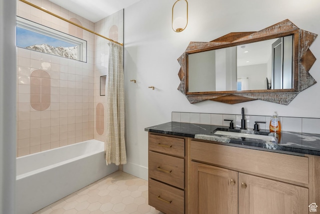 bathroom featuring tile patterned flooring, shower / bath combo with shower curtain, and vanity