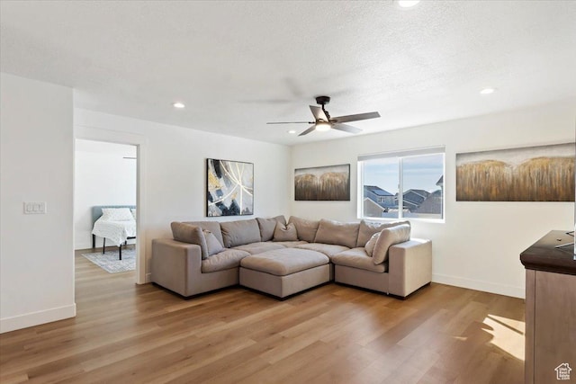 living area featuring recessed lighting, baseboards, light wood finished floors, and ceiling fan