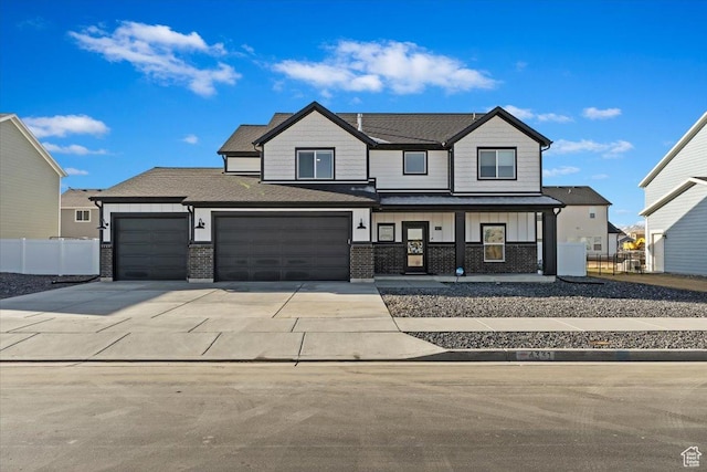 modern farmhouse style home with board and batten siding, fence, a porch, driveway, and an attached garage