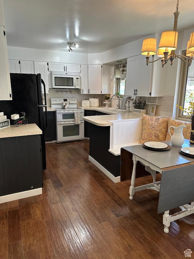 1653 S 500 E, Bountiful, UT 84010 - kitchen with white appliances, light countertops, a peninsula, backsplash, and dark wood finished floors