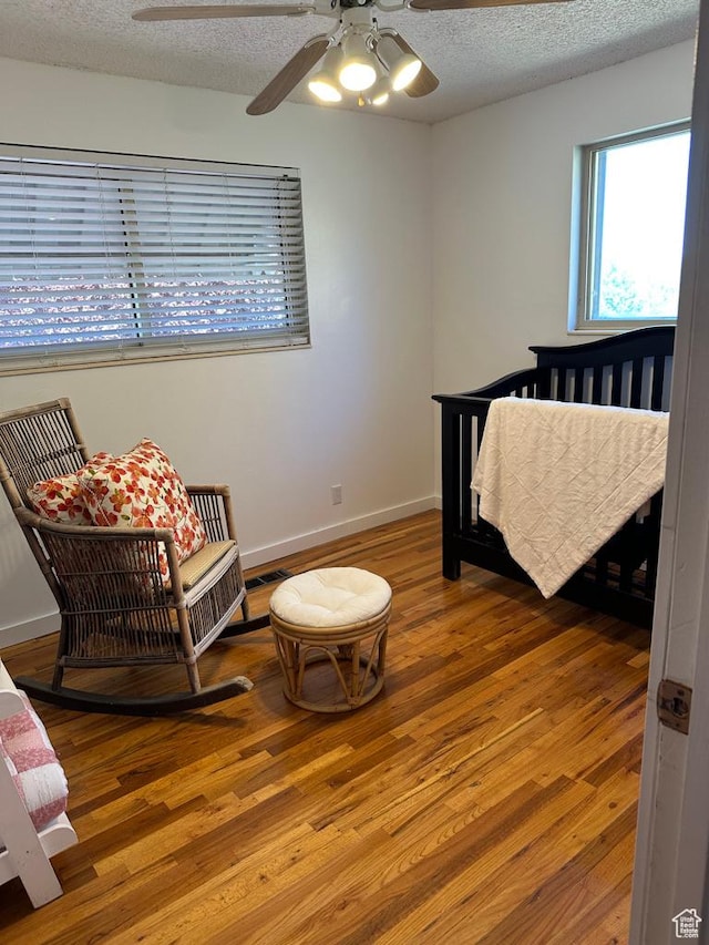 1653 S 500 E, Bountiful, UT 84010 - bedroom featuring wood finished floors, a textured ceiling, baseboards, and a ceiling fan