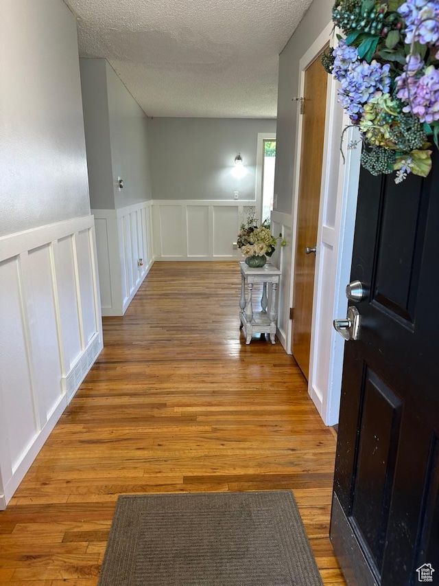 1653 S 500 E, Bountiful, UT 84010 - hall featuring a decorative wall, wainscoting, wood finished floors, and a textured ceiling