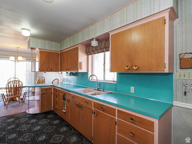 1325 E Milne Ln S, Cottonwood Heights, UT 84047 - kitchen featuring a sink, wallpapered walls, a peninsula, brown cabinetry, and light countertops