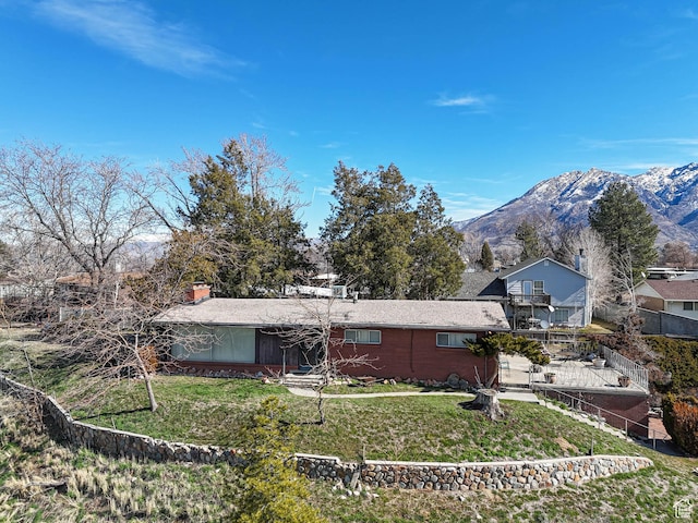 1325 E Milne Ln S, Cottonwood Heights, UT 84047 - rear view of property featuring a lawn, a mountain view, and a chimney