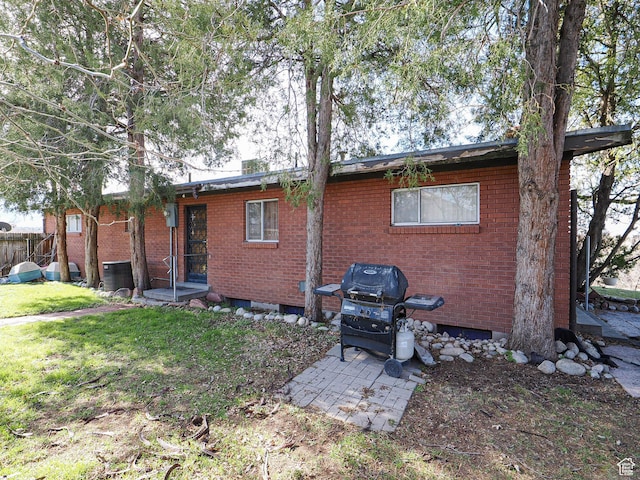1325 E Milne Ln S, Cottonwood Heights, UT 84047 - rear view of property with a patio, brick siding, a lawn, and fence