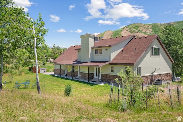 1762 S Hobblecreek Haven Rd, Springville, UT 84663 - back of property with stucco siding, stone siding, a patio area, a chimney, and a mountain view