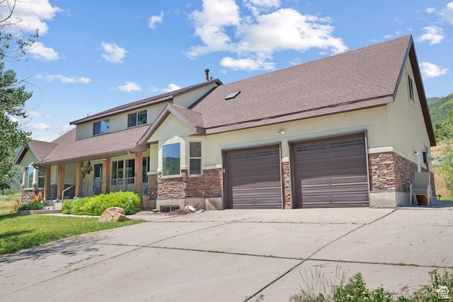 1762 S Hobblecreek Haven Rd, Springville, UT 84663 - view of front of house featuring stone siding, stucco siding, driveway, and covered porch