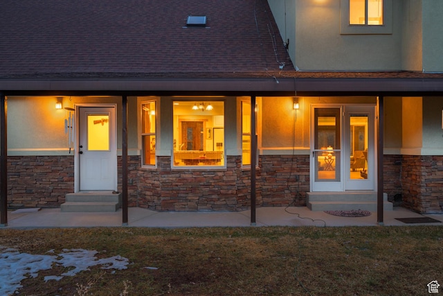 1762 S Hobblecreek Haven Rd, Springville, UT 84663 - view of exterior entry featuring stone siding, a shingled roof, stucco siding, and a lawn