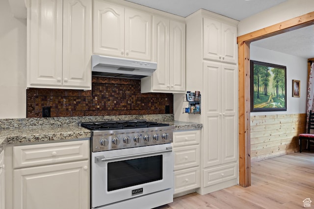 1762 S Hobblecreek Haven Rd, Springville, UT 84663 - kitchen featuring high end stove, under cabinet range hood, light wood-style flooring, light stone counters, and white cabinets