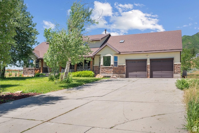 1762 S Hobblecreek Haven Rd, Springville, UT 84663 - view of front facade featuring stucco siding, stone siding, driveway, and an attached garage